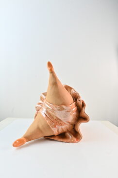 Female ceramic dancer sculpture lying down in a relaxed ballet pose